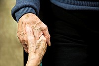 Old man and woman holding hands