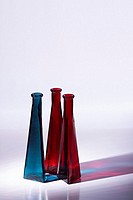 Blue and red decorative glass vases  Side lit to cast colourful reflections  Isolated  Copy space