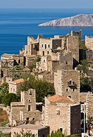 The stone tower houses the village of Vathia and the dramatic coast of the Deep Mani in the background, Southern peloponnese, Greece