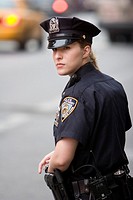 A female police officer watches traffic in New York City New York USA June 4 2008