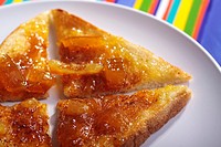 Sliced toast with marmalade on a white plate