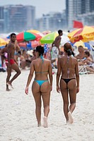 Beautiful young Brazilian woman walking along Copacabana Beach in Rio de Janeiro in Brazil