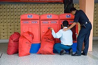 Postman emptying letter boxes at the central Post Office in Johor Baru Malaysia