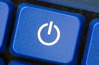 Close-up of a white power switch symbol on blue key