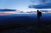 A hiker ascending the Jewell Trail enjoys the views at sunset  Located in the White Mountains, New Hampshire USA