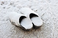 A pair of clogs covered with snow