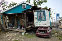 A home sits atop a car 9 months after Hurricane Katrina, in the Lower Ninth Ward, New Orleans