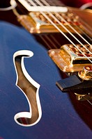 The violin hole and pickups/strings on an electric guitar Gretsch - detail