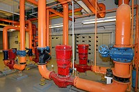Electrical heating control and water pipes in the boiler room of a highrise office building