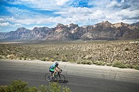 Cyclist rides through Red Rock Canyon State Park outside Las Vegas, NV. USA