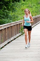 30 year old blonde woman jogging in work out clothes