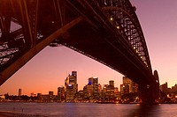 The Sydney skyline at sunset framed by the Harbour Bridge from North Sydney