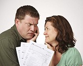 Married couple with United States 1040 tax forms feeling anxious about their taxes