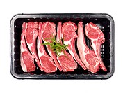 Supermarket packaged lamb chops isolated against a white background