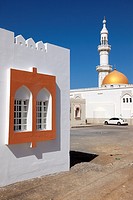 facade of a house with window and mosque with minaret in the village of Sur, Ash Sharqiyah Region, Sultanate of Oman, Asia