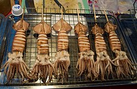 Squid on a stick for sale in a night market in Northern Thailand