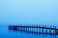 Early morning fog surrounds a dock.