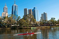 Rowers on the Yarra River against the backdrop of the Melbourne skyline