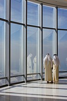 Two Emirati men in the top of the Burj Khalifa, the tallest building on the world, in Dubai UAE