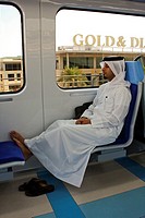 Emirati man with traditional dress sleeping inside Dubai Metro