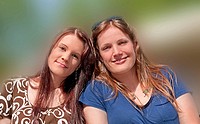 This stock photo are two young adult Caucasian brunette women both with long hair and smiling who are both sisters and friends They are in their early...