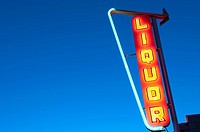 Needles, CA - A neon liquor sign shines in the dark along Historic Route 66