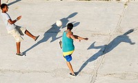Young Cubans play football in a park, in Havana, Cuba