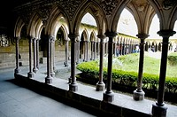 Cloisters and courtyard garden at Mont Saint-Michel, a fortified medieval monastery on an island in Normandy, France.