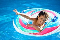 little girl waving happy in a swimming pool