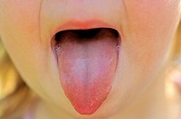 Child puts out tongue, two years old