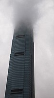 IFC tower in Hong Kong covered with clouds.
