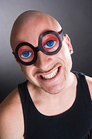 Bald man wearing funny glasses, smiling, portrait