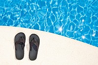 Shot of a Pair of Flip Flops next to the Pool