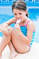 Shot of a Cute Blonde Girl On Holiday by the Pool  Eating an Ice Lolly
