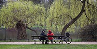 People sitting on a bench at Royal Baths Park, Warsaw Poland