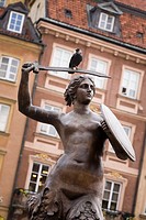 The Warsaw Mermaid statue, bird sitting on the sword  Old Town Market Place, Warsaw Poland