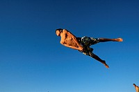 A boy jumps into the sea at ´Bikini´ beach during a summer day in the northern Spanish town of Santander