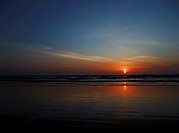 This stock photo is a stunning sunset at the beach as the sun is just about to dip over the horizon Horizontal format this conveys of concepts of vaca...