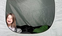 Shot of a Young Girl with a Big Smile in her Tent