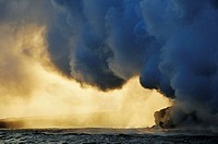Steam rising off lava flowing into ocean at sunset, Kilauea Volcano, Hawaii Islands, United States