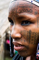 A Beautiful Peul / Fulani girl covered with facial tattoos in the Benin / Niger border area.