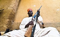 A Mossi chief holding his riffle in his village in Central Burkina Faso.