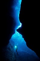 France marseille arc en ciel cave scuba diver shining a flashlight underwater