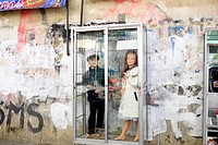 Child mannequins in a glass case, advesrtising clothing, street scene in El Alto, Bolivia