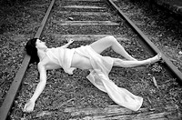 Female resting on railway track