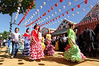 Abril, 20, 2010 Spain Seville April Fair. A crowd of people attend today the first real day of the ´feria de Abril´ of Seville Many women dresses with...
