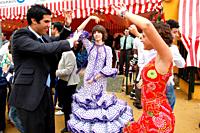 Abril, 20, 2010 Spain Seville April Fair. A crowd of people attend today the first real day of the ´feria de Abril´ of Seville Many women dresses with...