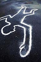 A chalk outline of a body on the ground as if at a crime scene.