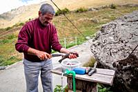 A man cleannig fish in Olgunlar, Yusufeli, Artvin, Turkey, Asia, 2010