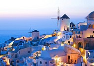 Iconic view of Oia village Santorini with windmills at sunset